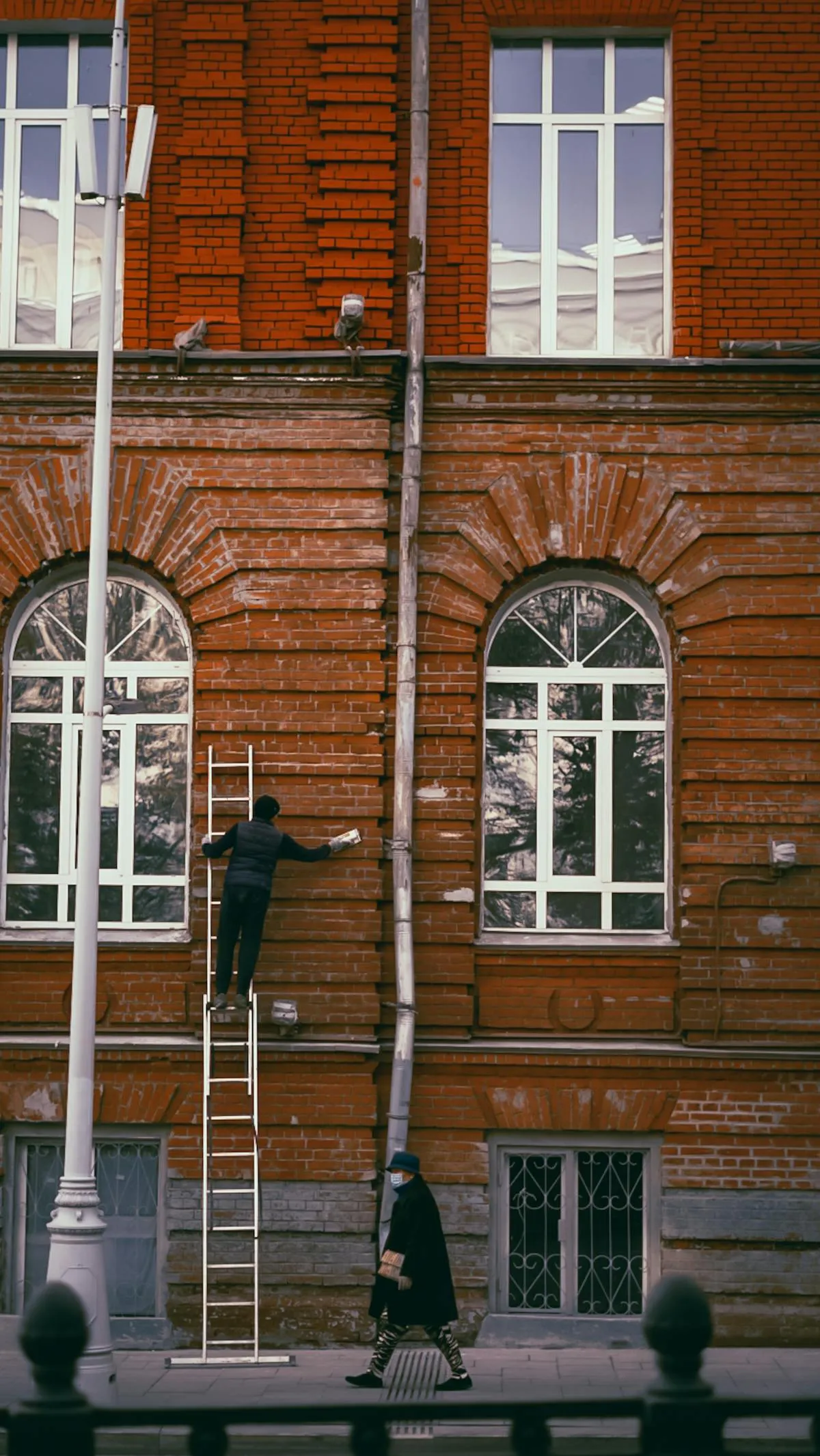 EPA RRP certified contractor setting up lead-safe containment for pressure washing pre-1978 building