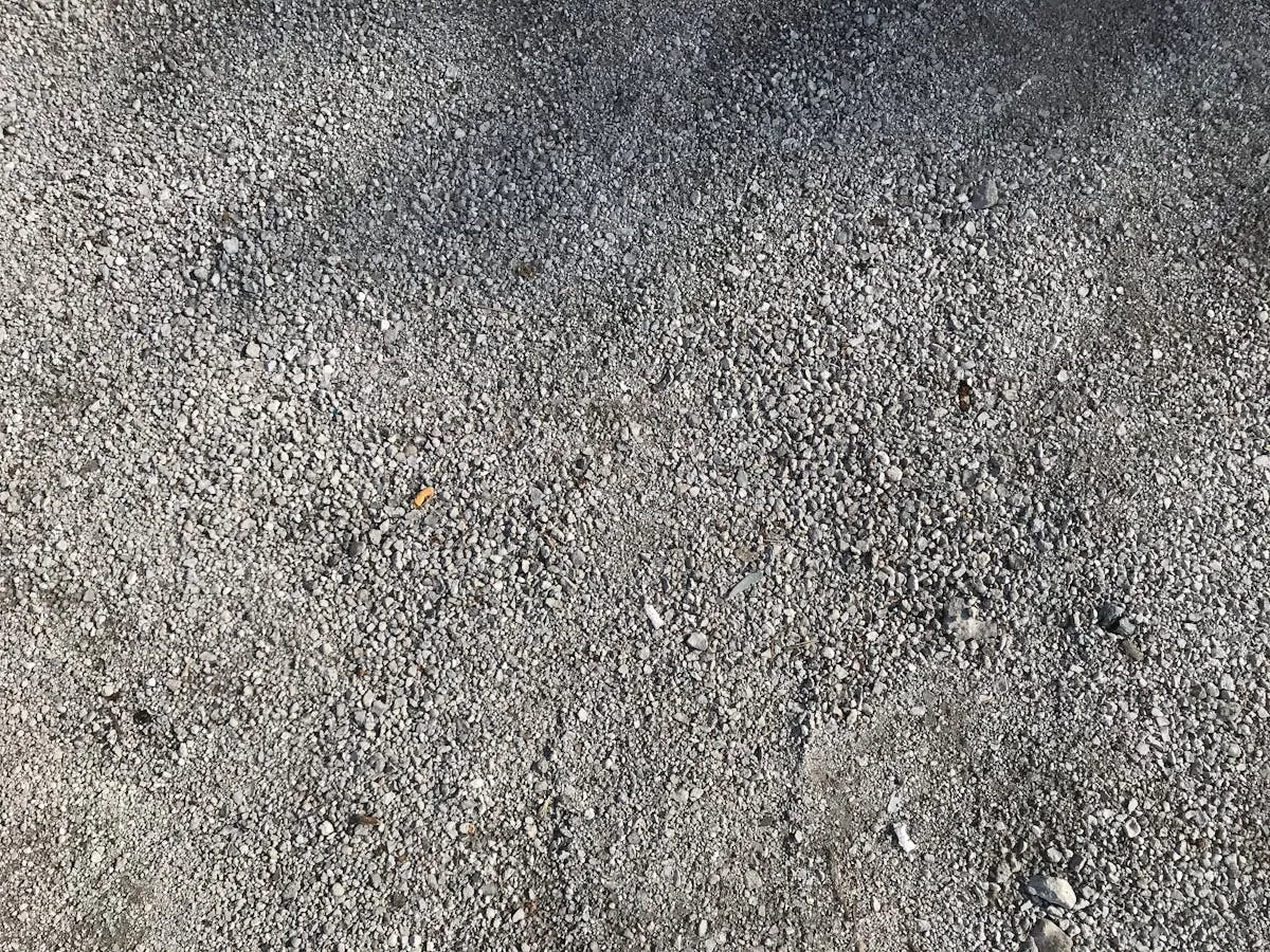 Applying concrete sealer with roller to clean driveway surface