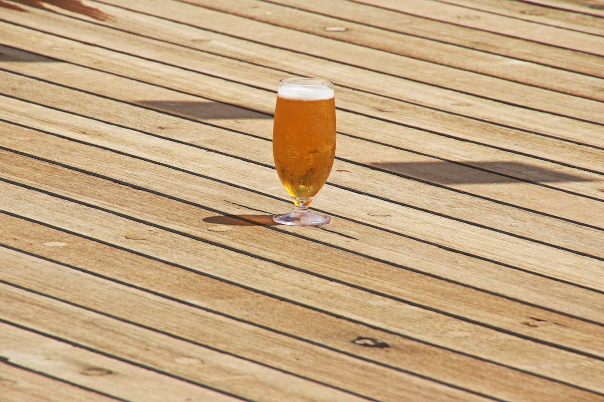 Clean wooden deck with furniture, showing restored wood grain